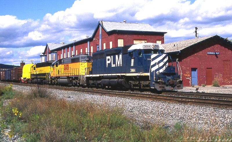 Hornell NY
CP/D&H train BUEB passes the boarded up Hornell NY passenger station, which once housed Conrail's Southern Tier dispatcher.  The parade of colorful units across the southern tier continues, with leased PLM SD40 #3004 leading Armour Yellow GATX SD40 #2004 and a bright yellow and black NYS&W ex-BN SD45.
Photo Copyright © 2008 Tim Baldwin
Keywords: hornell;ny;cp;d&h;conrail;plm;sd40;gatx;nys&w