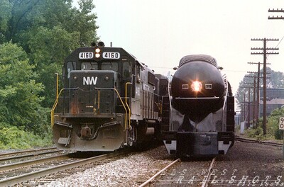 Generation Gap
N&W #611 rests at Erie PA while GP38-2 #4160 and her slightly older high hood GP30 sibling hustle merchandise east to the Buffalo NY connection with the D&H
Keywords: n&w;611;erie;pa;gp38-2;buffalo;d&h