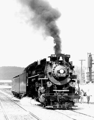 NKP 2-8-4 #765 Gang Mills NY
Nickel Plate Berkshire #765 rests quietly at Gang Mills yard near Bath and Corning NY.  In a short while she will lead a sizeable railfan contingent on a merry chase as she wends her way west through the scenic Canisteo River valley to Hornell and on to Buffalo.  This was the day that this writer fell in love with the ex-EL Southern Tier Line
Keywords: npb;nickel plate;gang mills;bath;corning;ny;buffalo;2-8-4