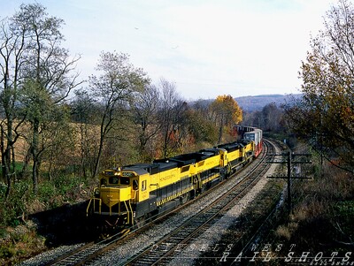 The view from Hunts Hollow Road
A quartet of NYS&W yellowjackets race west with Sea-Land doublestacks in tow through rural Hunt NY on a clear fall day.  
A few miles west lies the landmark bridge over the Genesee River Gorge at Portage NY. 
©Photo Copyright 2008 Tim Baldwin
Keywords: hunt;ny;genesee river;portage,ny