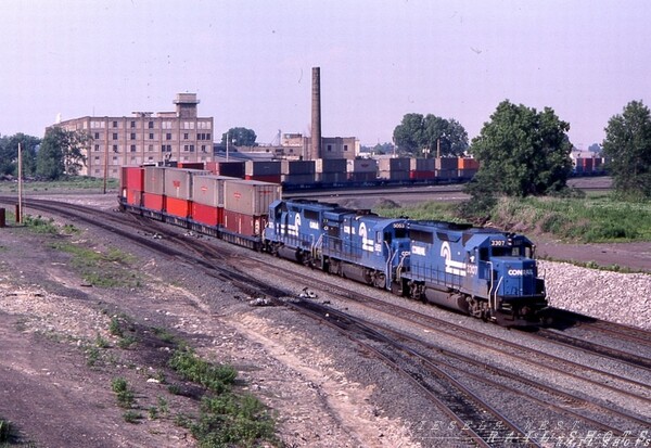 CR TV-501 Seneca St Buffalo NY
Conrail's APL doublestack TV-501, behind a pair of GP40-2s sandwiching a B36-7, swings off the Bison runner onto the westbound main at the former site of FW tower, as viewed from the Seneca St overpass in Buffalo NY.
Photo Copyright 2008 Tim Baldwin
Keywords: cr;conrail;buffalo;b36-7;gp40-2;bison;fw tower;seneca;stacks;container