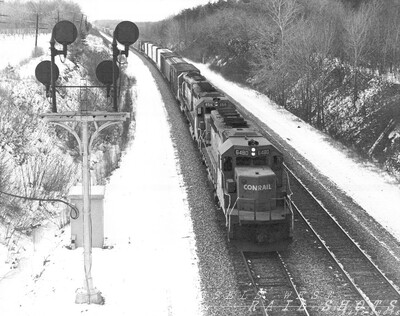 Conrail eastbound in winter
A trio of ubiquitous SD40-2s leads an eastbound Conrail merchandise freight under a rural bridge midway between Dunkirk and Silver Creek, NY.
Photo Copyright 2008 Tim Baldwin
Keywords: cr;conrail;dunkirk;sd40-2;merchandise;silver creek;ny