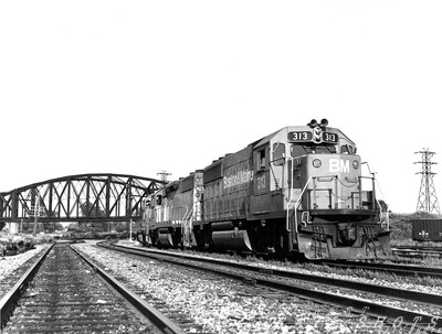 B&M GP40-2 #313 William St. Buffalo NY
In the months preceding the Guilford purchase of the D&H, a pooled power arrangement saw B&M geeps and MEC power visiting the North Yard in Buffalo.  Here, a trio of pooled geeps idles at the William Street end of the yard.  The ex-DL&W bridge in the background was torn down not long after this photo was taken.
Photo Copyright 2008 Tim Baldwin
Keywords: b&m;gp40-2;buffalo;ny;dl&w