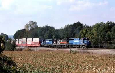 A hill to climb
Eastbound D&H Sea-Land doublestack train SLN-8 struggles up Attica Hill with two B&M bluebird GP38-2s bracketing an ex-D&H (nee-RDG) GP39-2 in fresh Guilford paint.  SLN-8's circuitous CSX-B&P-D&H-NYS&W routing and varied motive power assignments were a joy to Western NY railfans.  The train carried the symbol DTV8 while utilizing trackage rights over Conrail's Southern tier Line between Buffalo and Binghamton.
Photo Copyright 2008 Tim Baldwin
Keywords: attica hill;attica;d&h;sea-land;b&m;bluebird;gp38-2;ny