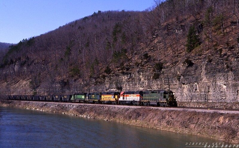 Mixed Bag
An Eastbound, carrying coal loads that originated on the P&LE, winds its way through the scenic Canisteo River valley behind a mixed consist of locomotives in five different paint schemes.  Leading the pack is ex-RDG GP39-2 #7410 in D&H patched Reading green, followed by a leased BAR GP38-2, a leased ex-Chessie GP40-2, another ex-RDG GP39-2 in a modified blue D&H scheme, and an ex-BN SD45 now owned by designated operator NYS&W.  The train is bound for a generating plant in Bow NH.
Copyright © 2008 Tim Baldwin
Keywords: coal;p&le;canisteo;river;bar;gp38-2;reading;bow;ny