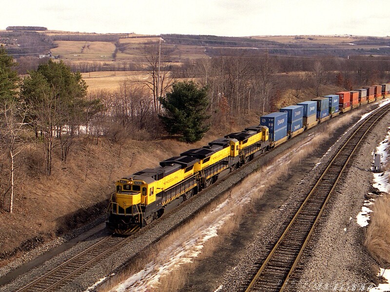 D&H HAN-1 Canaseraga NY
A trio of even-numbered B40-8s, led by NYS&W #4002, passes beneath the highway overpass in the small town of Canaseraga NY.  Westbound HAN-1 was a joint CSX, B&P, D&H and NYS&W venture, and the B40-7 fleet had been financed by major player CSX.
Photo Copyright 2008 Tim Baldwin
Keywords: d&h;canaseraga;ny;b40-8;nys&w;b&p;csx