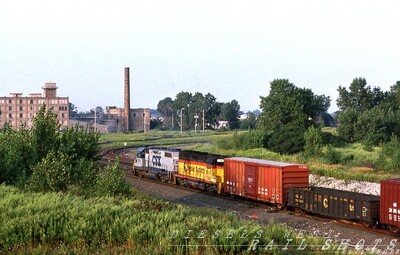 CSX CG-41 Seneca St Buffalo NY
A pair of GP40-2s lead CSX CG-41 as it heads west on Conrail tracks, passing the former site of FW Tower, as seen from the Seneca St bridge in Buffalo NY. The late afternoon sun intensifies the colorful consist.
Photo Copyright 2008 Tim Baldwin
Keywords: csx;chessie;seneca;buffalo;gp40-2;fw tower