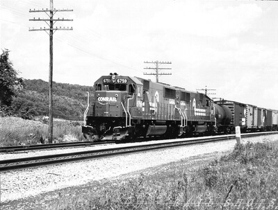 CR SD50 #6759 BUOI Arkport NY
Brand new Conrail SD50 #6759 leads BUOI through Arkport NY, just north of Hornell.  A pair of the big units could haul the longest Conrail freights up Attica Hill with ease, while tenant D&H's trains required pushers from among a motley crew of 4-axle power.
Photo Copyright 2008 Tim Baldwin
Keywords: cr;cr 6759;sd50;arkport;ny;hornell;attica