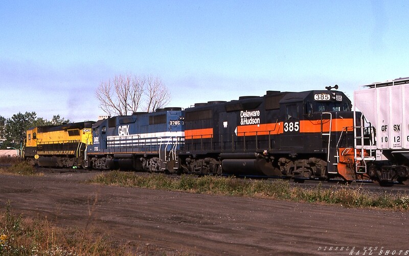 D&H GP39-2 #385 William St Buffalo NY
Led by NYSW B40-8 #4024 and GATX GP40 #3705, renumbered D&H GP39-2 #385, seen approaching William St, still wears Guilford paint, though the large 'G' on the long hood has been blacked out.  Following CP Rail's subsequent purchase of the D&H, 4-axle motive power would become increasingly rare on the Southern Tier Line.
Photo Copyright © 2008 Tim Baldwin
Keywords: gp39-2;buffalo;ny;nysw;b40-8;gatx;d&h;guilford