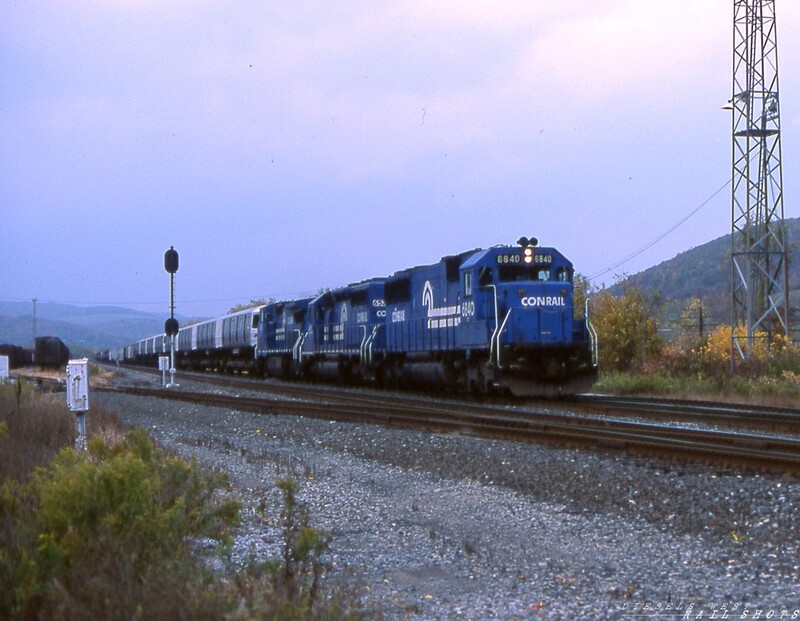 CR SD60 #6840 East Hornell NY
One a hub of activity in its Erie Lackawanna heyday, Hornell Yard in the Conrail era saw use mostly as a car storage facility.  The former EL shop complex at this date was being used by Morrison-Knudsen to refurbish commuter rail cars.  Eastbound BUOI, behind CR SD60 #6840, an SD40-2, and a GE CW40-8 are seen leaving East Hornell NY.  The scenic Canisteo River Valley lies ahead.
Photo Copyright © 2008 Tim Baldwin
Keywords: sd60;conrail;cr;hornell;ny;erie lackawanna;morrison knudsen;canisteo