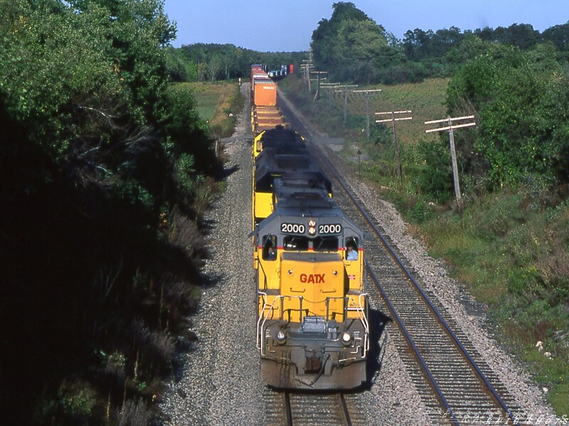 GATX SD40-2 #2000 Attica Hill
A westbound D&H stack train works its way up Attica Hill on Conrail's Southern Tier Line with leased GATX SD40-2 #2000 leading two former Burlington Northern units now wearing NYS&W paint.  CP Rail, the new owner of the Bridge Line, would lease a variety of colorful units from GATX, PLM and others, continuing a long history of interesting lashups on the D&H.
Photo Copyright 2008 Tim Baldwin
Keywords: gatx;sd40-2;attica;d&h;southern tier;burlington northern;nys&w