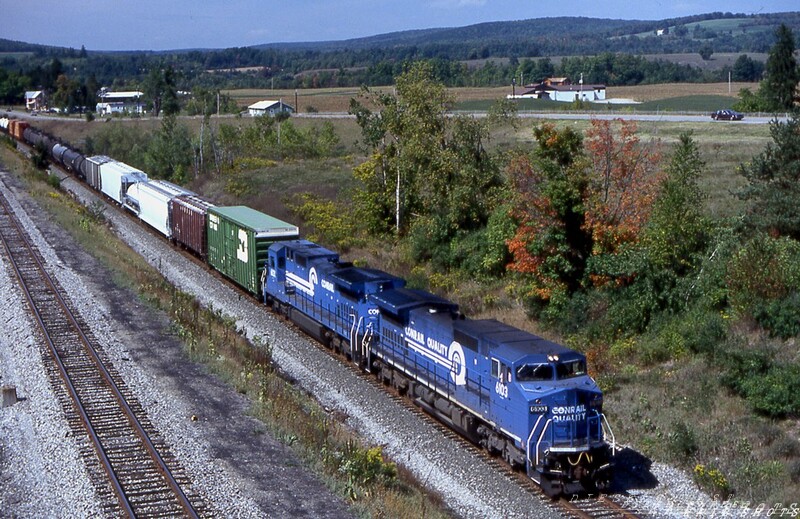 CR C40-8W #6103 Canaseraga NY
The miles and road grime are already beginnning to add up for Conrail C40-8W #6103 and her C40-8 cousin as they lead Buffalo NY to Oak Island NJ freight BUOI beneath the highway overpass at Canaseraga NY, north of Hornell.  Conrail dispatchers invariably lined the home road's freights for the fast iron on track one, while tenant D&H's eastbound movements frequently used the 10 MPH jointed rail of track two between Portage and Hornell.
Photo Copyright © 2008 Tim Baldwin
Keywords: c40-8;canaseraga;conrail;cr;oak island;buffalo;hornell;d&h