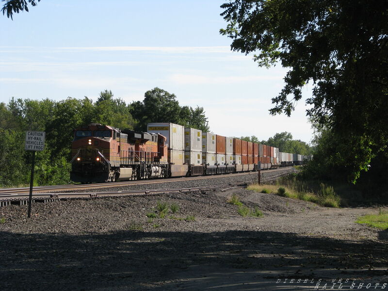 BNSF WB Double Stack
BNSF 5221 and 8290 lead more domestic double stacks and trailers through Edgerton, Kansas on 9/21/2014. This is a very typical consist for the TransCon, 53 foot containers followed by 53 foot trailers
Keywords: bnsf;double;53;domestic;edgerton;kansas;transcon;trailers