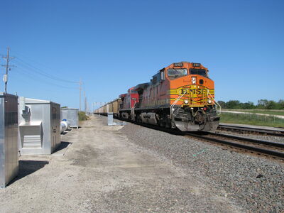 BNSF WB Feed Train
BNSF 5101, CP 9514 and BNSF 7125 on a west bound loaded feed train. 
The cars are standard rotary gon coal cars with a retractable cover over the load. 
I believe this train is headed to Texas with either chicken feed or poultry feed. The CP 9514 was running off miles on the BNSF and had been in the area for several weeks.
Keywords: BNSF;dash 9;feed,kansas;cp