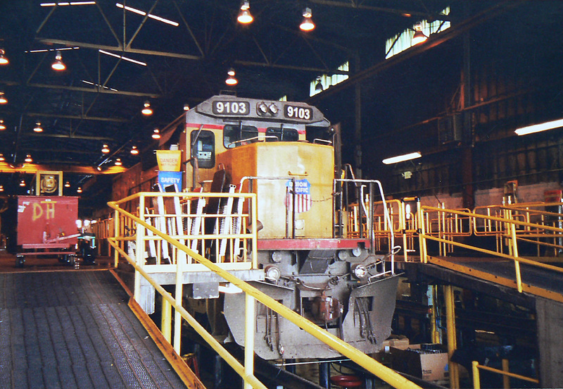 UP Dash 8 #9103 at Burnham shops
Union Pacific 9103 C40-8 receives repairs over the pit in a Denver maintenance facility
Keywords: up;dash 8;9103;c40-8;denver;burnham;shops