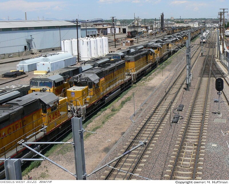 U.P.'s Burnham Shops yard - Denver
U.P.'s Burnham Shops yard (northern half, looking north from the 8th street bridge)These locomotives, most having been in revenue service for many years, are now in storage. The 20+ SD9043AC's, however, have been pulled from service indefinitely. A maintenance hog from the start, these lower HP units, aren't moving anything anymore. 
Keywords: burnham;shops;engine;storage;yard